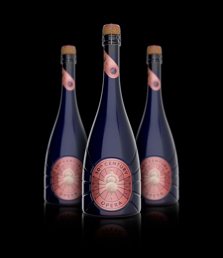 Three blue wine bottles with rose-colored labels on dark background