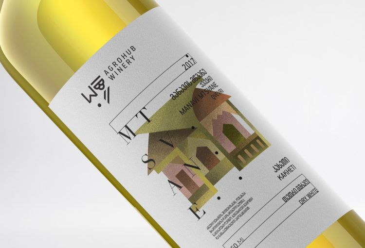 Clear white wine bottle with white label and graphic design of a elegant house