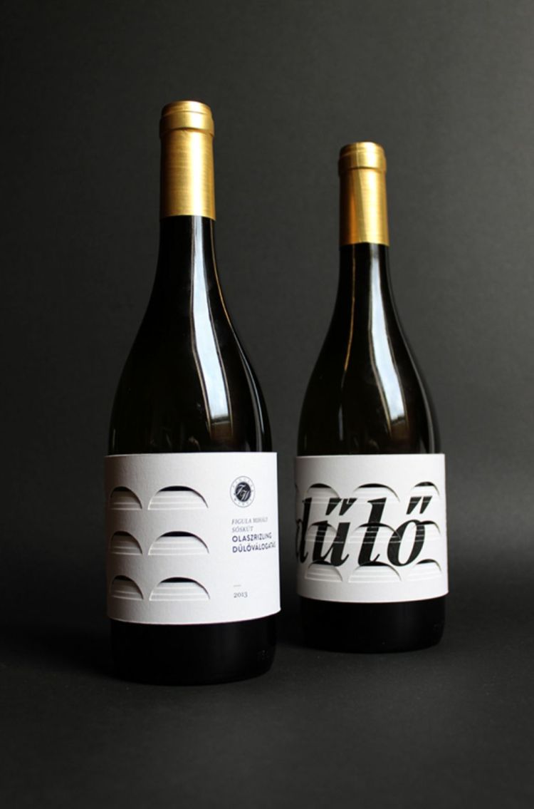 Black wine bottles with white labels that say "dulo"