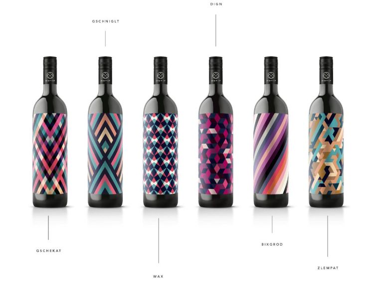 Six black wine bottles with colorful abstract designs on white background