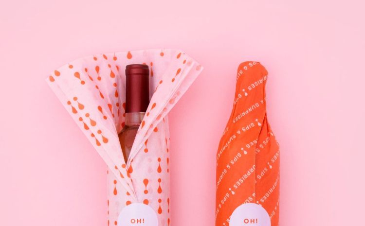 Clever wine packaging with two bottles wrapped on thin paper with one in pink and one in orange