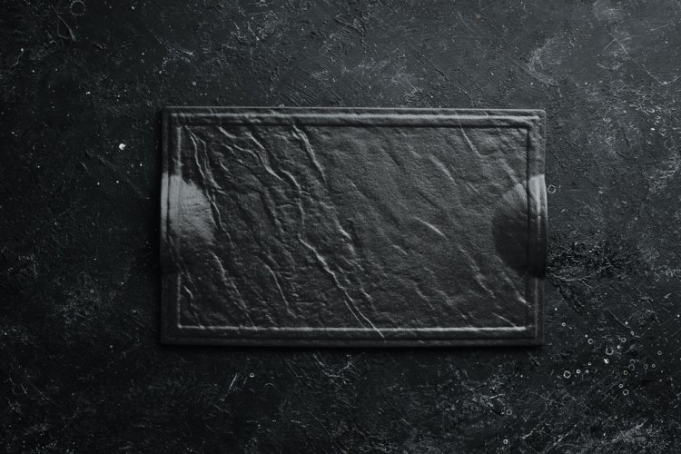 Black plate on a black stone background