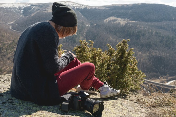 Filmmaker Taking a Break on a Mountainside